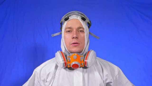Scientist virologist in respirator. Slow motion. Man close up look, wearing protective medical mask. Concept health safety N1H1 virus protection coronavirus epidemic 2019 nCoV. Chroma key blue film.