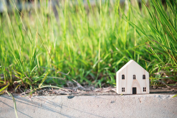 House model on wood in natural background. Ideas for applying for home loans Saving money to buy a house.