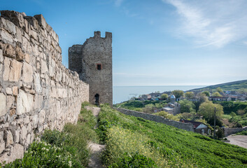 Fototapeta na wymiar Medieval wall and tower of Genoese fortress in the city of Feodosia on the Crimean Peninsula, built by colonists from Genoa in the 14th century