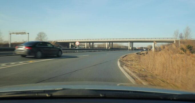 Driving a car on an highway entering multi-lane road