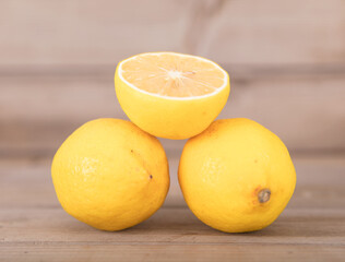 Two fresh lemons and half a cut lemon