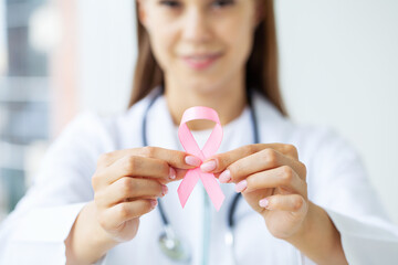 Pink ribbon for breast cancer awareness in doctor