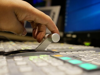 hand adjusting on switcher buttons in studio TV station,Television Broadcast.