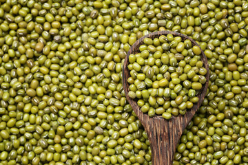 Fresh seed green beans in wooden spoon.