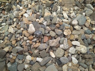 multicolored stones pebbles on the shore for nature background rock