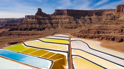 Aerial view of potash ponds near Moab Utah. The ponds have an array of colors in the middle of the red desert rock landscape. Ponds are used to extract salt.
