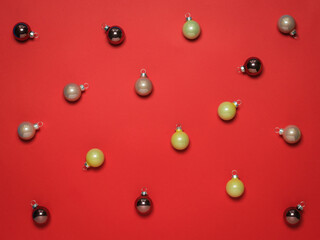 Colorful Christmas tree balloons on a red background.