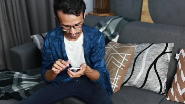 Young man using smartphone with social media network during stay at home, connection, communication and work from home concept