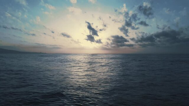 Cinemagraph loop of aerial dramatic sunrise on the sea