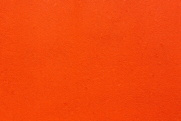 abstract background with the texture of the orange cement wall as a backdrop has a space for text.