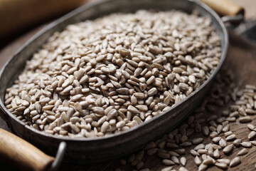 sunflower seeds in iron tray on rustic background
