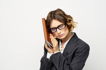 Business woman with notepad and glasses work light background cropped view of suit model.
