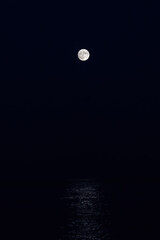 Full moon reflection over the evening sea in Spanish Costa Brava