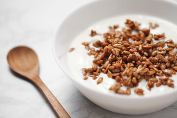 yogurt with sunflower seeds in a ceramic bowl