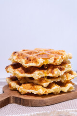 Waffles with hot maple syrup. Honey pouring on a fresh waffles. vertical photo