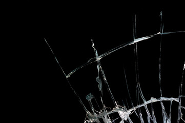 broken mirror and glass from impact on a black background in cracks in the form of an isolated abstraction