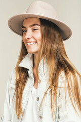 smiling happy blond woman in light pink hat