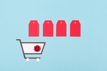 Super Sale day or Singles day concept. Shopping trolley and red tags on blue paper background.