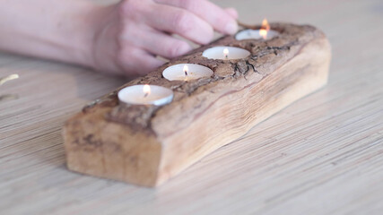 Fototapeta na wymiar human hand lighting the candle. Praying, faith, religion concept. selective focus