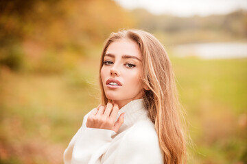 Beautiful elegant woman in autumn park, toned color.