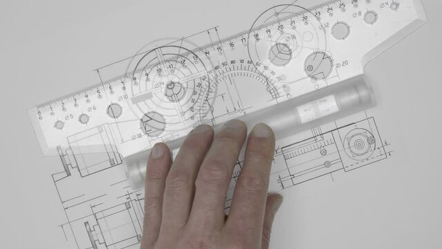 An engineer (student, apprentice, designer) makes a drawing of the mechanism using a transparent roller ruler and easily draws parallel lines with a pencil