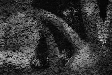 Monochrome abstract background in dark colors.Oil paint on a concrete wall.Selective focus.