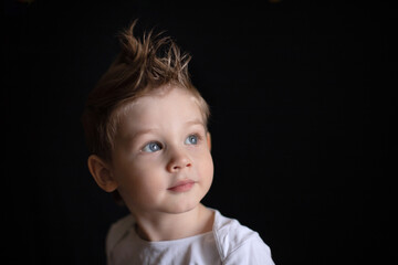 portrait of a boy on a black background
