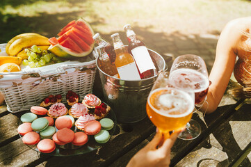Picnic in the park with macaroon cookies and cold drinks