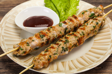 Minced pork skewer kebab with sauce