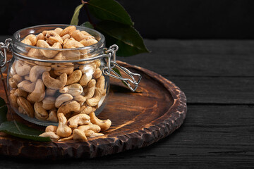 Bowl with cashew nuts on wooden table. Delicacies