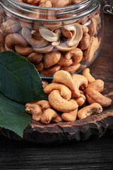 Bowl with cashew nuts on wooden table. Delicacies
