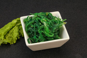Green Chuka Seaweed Salad Isolated on White Background Top View. Wakame Sea Kelp Salat