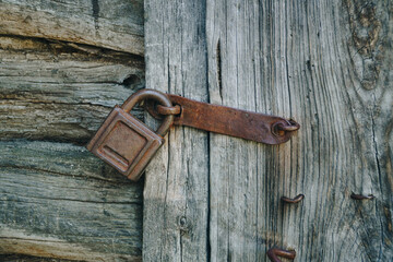 Old rusty lock on an old wooden door