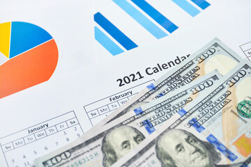 Successful 2021 year in generating profits for businesses with dollars on paper charts