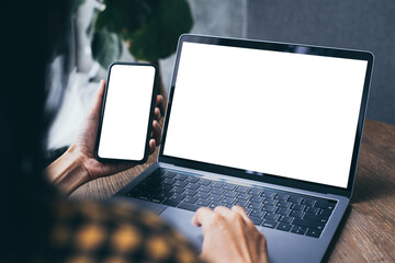 computer,cell phone mockup.hand woman work using laptop texting mobile.blank screen with white background for advertising,contact business search information on desk in cafe.marketing,design