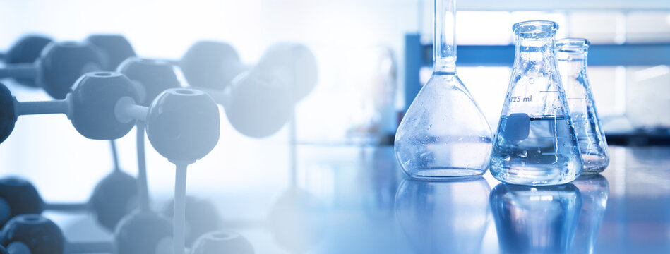 water in flask with molecular structure science equipment in laboratory banner blue background