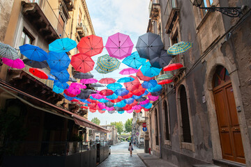 Colorful umbrellas - decoration on streets in Catania city center, Sicily, Italy
