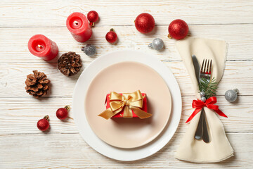 Concept of New year table setting with gift box on wooden table