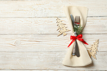 Napkin with New year cutlery on wooden background