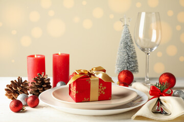 Concept of New year table setting with gift box on wooden table