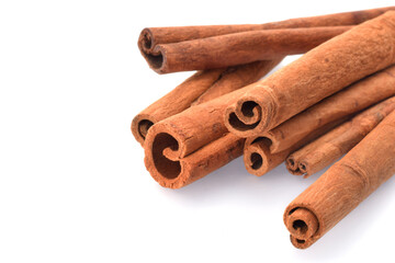 Spicy cinnamon sticks macro isolated on white with free space for text