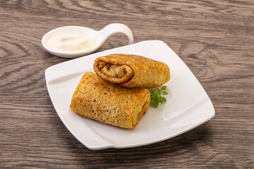 Staffed pancakes served sour cream