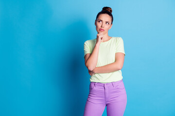 Photo of questioned lady touch hand chin look empty space think isolated over blue pastel color...