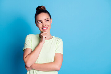 Photo of minded girl touch fingers chin look empty space think isolated over blue pastel color...