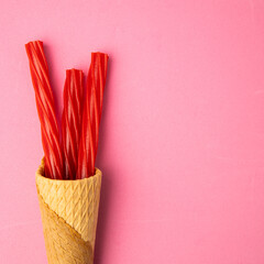 red sweet licorice on pink background
