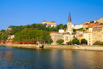 View of Saone river embankment with Saint George church. Lyon, France.