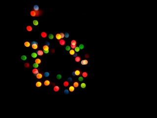 The multicolored side's or boke on a black background. Merry Christmas and happy New Year. Christmas background.