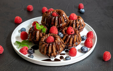 Mini chocolate cakes with chocolate and fresh berries