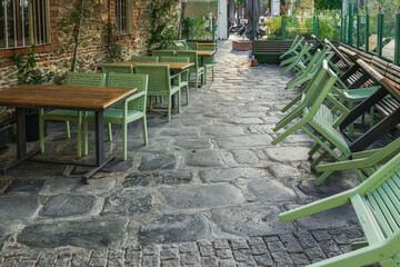 Empty outdoors tables as Coronavirus measures affect business & life in Greece. Closed bar restaurants chairs at the city center in Thessaloniki, after government tries to prevent COVID-19.