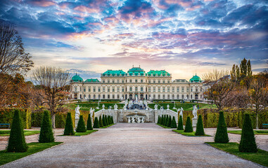 Panoramic evening view of the famous Belvedere Castle, built as the summer residence of Prince Eugene of Savoy in Vienna, Austria. View of the fountain, park and Belvedere in the autumn evening.